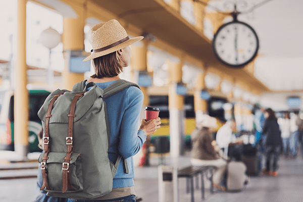 girl with backpack at the train station