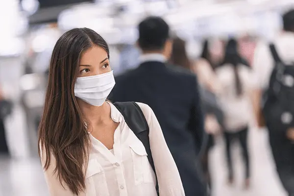 woman with a facemask on in a crowded place